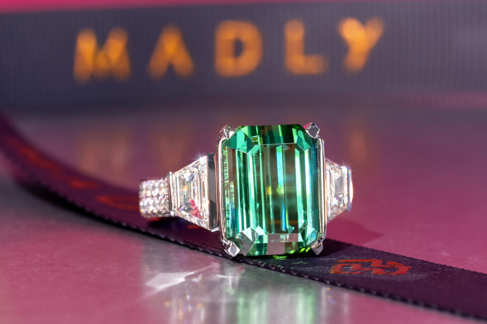 Large Rectangle Tourmaline with a Diamond-Studded Band and Two Side Diamonds with the MADLY Logo in the Background