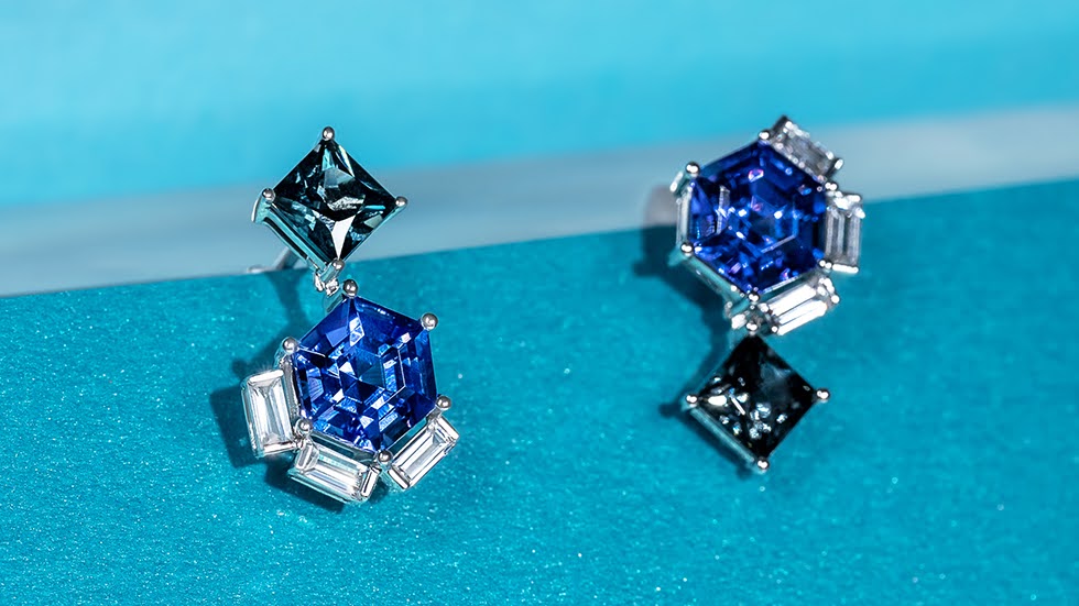 Asymmetric dangle ear studs and earrings featuring square-cut grey spinels and hexagon step fancy cut tanzanite with three baguette diamonds at each corner.