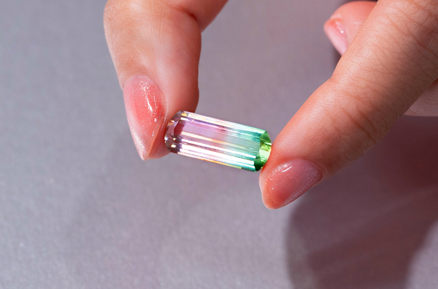 A 7.5 carat Watermelon Tourmaline shows a unique gradient of colours from pink to white to green and was specially cut to bring out these hues.
