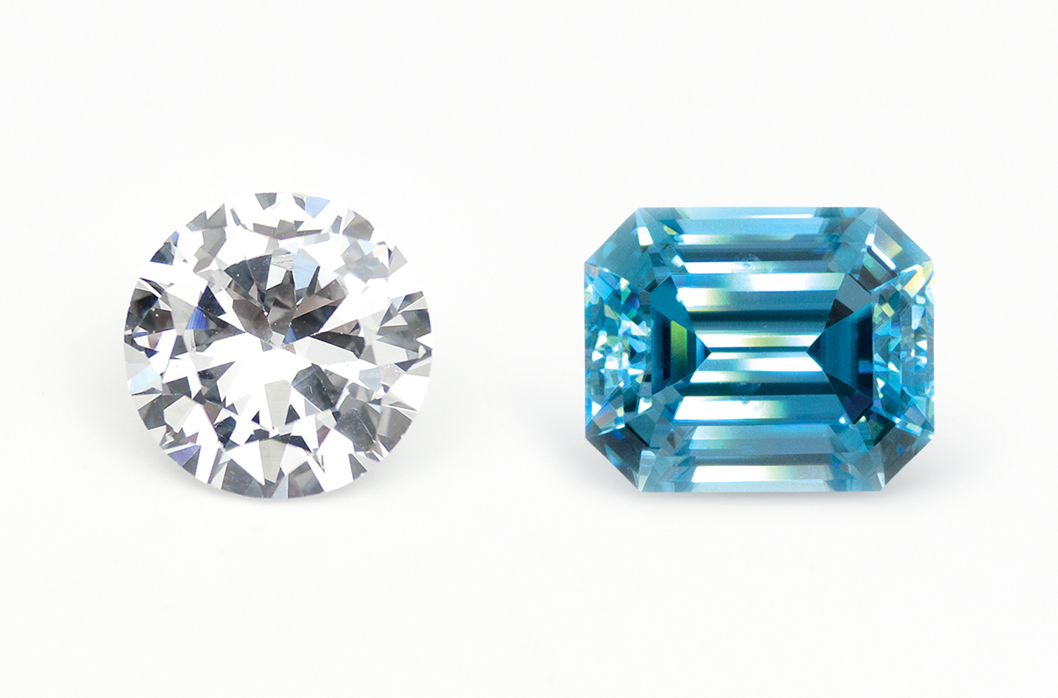 A brilliant round Cubic Zirconia next to an emerald/step cut blue Zircon.