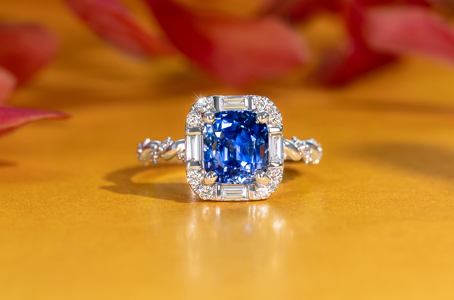 An cushion cut blue Sapphire encircled by diamonds in the style of MADLY's signature halo design, showcasing elegance and luxury.