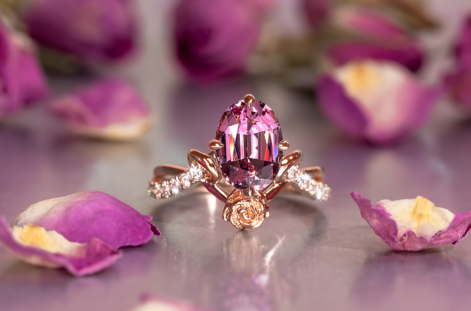 A pink Spinel ring with a feminine touch of rose gold and a gold rose, with melee diamonds lining the band.