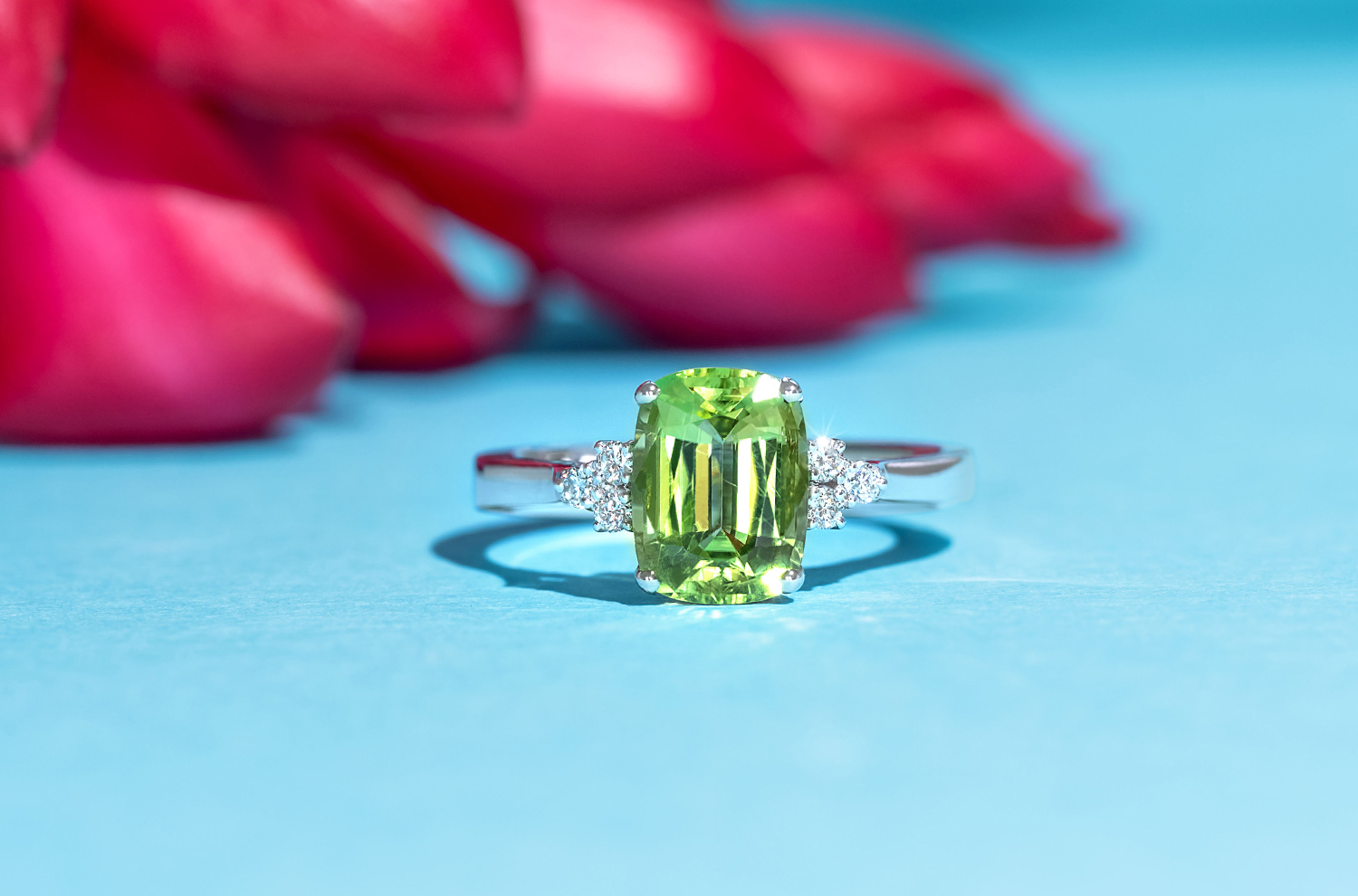 A dainty cushion cut peridot with melee diamonds accentuating its sparkle.